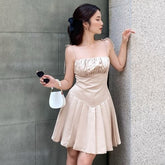 Silk mini dress with ruched bust, flared pleated skirt and delicate tie shoulder straps